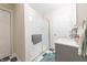 Bright bathroom featuring a tiled shower with glass doors, a modern vanity, and checkered tile floors at 282 N Mapleton St, Columbus, IN 47201