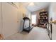 Bedroom featuring a treadmill, bookcase, storage, and lots of natural light from the window at 282 N Mapleton St, Columbus, IN 47201