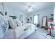 Bright bedroom with soft lighting, ceiling fan, a bed with many pillows, and a quaint décor at 282 N Mapleton St, Columbus, IN 47201