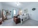 Cozy bedroom featuring a bed, chest, standing mirror, closet, and soft natural light from the windows at 282 N Mapleton St, Columbus, IN 47201