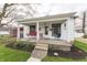 Charming front porch featuring a swing, seating, and well-manicured landscaping at 282 N Mapleton St, Columbus, IN 47201