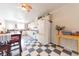 Functional kitchen features white appliances, checkered flooring, ample cabinetry, and an adjacent dining area at 282 N Mapleton St, Columbus, IN 47201
