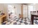Charming eat-in kitchen with checkered floors and additional pantry storage and a glimpse of the living room at 282 N Mapleton St, Columbus, IN 47201