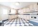 Bright kitchen featuring white cabinetry, blue countertops, blue and white checkered flooring, and ample natural light at 282 N Mapleton St, Columbus, IN 47201