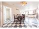 Eat-in kitchen featuring checkered floors, ceiling fan, and views of the cabinets and back entrance at 282 N Mapleton St, Columbus, IN 47201