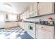 Well-lit kitchen boasts white cabinetry, blue countertops, a range, and eye-catching blue and white checkered flooring at 282 N Mapleton St, Columbus, IN 47201