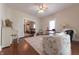 Open-concept living room boasts hardwood floors, ceiling fan, and seamless flow into adjacent living spaces at 282 N Mapleton St, Columbus, IN 47201