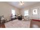 Cozy living room featuring hardwood floors, neutral walls, ceiling fan, and natural light from two bright windows at 282 N Mapleton St, Columbus, IN 47201