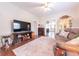 Comfortable living room featuring a decorative fireplace, media center, hardwood floors, and a cozy sofa at 282 N Mapleton St, Columbus, IN 47201