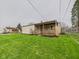 Backyard of a home, showcasing a well-maintained lawn and a covered porch area at 301 E 34Th St, Anderson, IN 46013