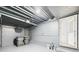 Unfinished basement showing concrete floor and walls, open ceiling, and utility hookups at 301 E 34Th St, Anderson, IN 46013