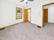 Bright bedroom with neutral carpet, white walls, wood trim, and a ceiling fan at 301 E 34Th St, Anderson, IN 46013
