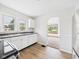 Modern kitchen with white cabinets, wood flooring, and stainless steel appliances at 301 E 34Th St, Anderson, IN 46013