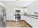 Modern kitchen featuring stainless steel appliances, white cabinets, and tiled backsplash at 301 E 34Th St, Anderson, IN 46013