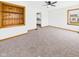Cozy living room with plush carpet, a built-in bookshelf, and ample natural light from the windows at 301 E 34Th St, Anderson, IN 46013