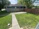 Spacious, grassy backyard with a walkway and a wooden fence at 3031 Nowland Ave, Indianapolis, IN 46201