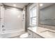 Bathroom featuring a white subway tile shower and vanity with a granite countertop, plus a window at 3031 Nowland Ave, Indianapolis, IN 46201