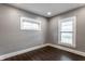 Neutral bedroom with hardwood floors, two windows, and gray walls at 3031 Nowland Ave, Indianapolis, IN 46201
