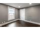 Empty bedroom features modern wood floors, a bright window, and neutral paint, providing a blank slate at 3031 Nowland Ave, Indianapolis, IN 46201