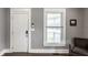 Inviting entryway featuring a classic white door, a window for natural light, and modern smart home features at 3031 Nowland Ave, Indianapolis, IN 46201