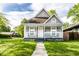 Charming home featuring a covered front porch, well-maintained lawn, and classic architectural details at 3031 Nowland Ave, Indianapolis, IN 46201