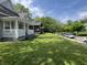 The side yard showcases the home's well-maintained landscaping and curb appeal in a serene neighborhood setting at 3031 Nowland Ave, Indianapolis, IN 46201