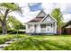 This lovely home offers a quaint front porch and lush landscaping, creating a welcoming curb appeal at 3031 Nowland Ave, Indianapolis, IN 46201