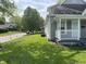 Well-maintained front yard with lush green grass, sidewalk, and cozy porch at 3031 Nowland Ave, Indianapolis, IN 46201