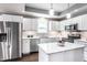 Bright kitchen featuring white cabinets, stainless steel appliances, granite countertops, and a center island at 3031 Nowland Ave, Indianapolis, IN 46201
