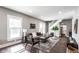 Bright living room with hardwood floors, neutral colors, and an open layout to the staircase and kitchen at 3031 Nowland Ave, Indianapolis, IN 46201
