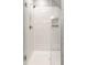 Shower stall featuring white subway tile, a glass door, and a recessed shelf at 3031 Nowland Ave, Indianapolis, IN 46201