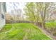 Expansive backyard with lush green grass, mature trees, and a wooden fence, creating a private outdoor space at 3051 Firestone Cir, Indianapolis, IN 46234