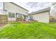 Charming backyard featuring a wooden deck, manicured lawn, and inviting patio furniture, ideal for outdoor relaxation at 3051 Firestone Cir, Indianapolis, IN 46234