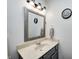 Well-lit bathroom with a framed mirror, neutral paint, and a single sink at 3051 Firestone Cir, Indianapolis, IN 46234