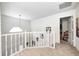 Second floor foyer overlooking the entryway, featuring neutral paint and carpeting, great natural light at 3051 Firestone Cir, Indianapolis, IN 46234