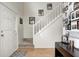 Inviting foyer with hardwood flooring, a staircase with white railing, and space for decor at 3051 Firestone Cir, Indianapolis, IN 46234