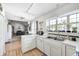 Open concept kitchen, featuring bright natural light, white cabinets, and a view to the Gathering room at 3051 Firestone Cir, Indianapolis, IN 46234