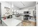 Well-lit kitchen featuring white cabinetry, stainless steel appliances, and a view to the dining area at 3051 Firestone Cir, Indianapolis, IN 46234