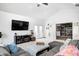 Comfortable living room with large TV, ceiling fan, and access to a second living space at 3051 Firestone Cir, Indianapolis, IN 46234