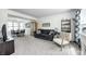 Comfortable living room adjacent to dining area, featuring neutral carpet and modern decor at 3051 Firestone Cir, Indianapolis, IN 46234
