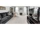 Bright living room with a decorative fireplace, contemporary furnishings, and plush carpeting at 3051 Firestone Cir, Indianapolis, IN 46234