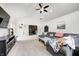 Bright living room with vaulted ceilings, ceiling fan, gray sofa, and TV, perfect for relaxation at 3051 Firestone Cir, Indianapolis, IN 46234