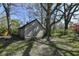 Rustic, abandoned outbuilding featuring weathered wood and boarded-up windows, surrounded by mature trees and a grassy lawn at 324 E Burgess Ave, Indianapolis, IN 46219