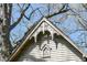 Close-up of a shed gable featuring decorative trim and detailing, set against a backdrop of trees at 324 E Burgess Ave, Indianapolis, IN 46219