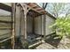 Shed with old wooden planks and stone foundation featuring a covered entry and weathered wooden columns at 324 E Burgess Ave, Indianapolis, IN 46219