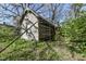 Charming shed featuring unique architectural details, partially obscured by scaffolding and greenery at 324 E Burgess Ave, Indianapolis, IN 46219