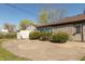 View of the backyard with patio, stone exterior, and a storage shed at 3255 W 30Th St, Indianapolis, IN 46222
