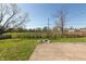 A spacious backyard featuring a fire pit, concrete patio and green grass at 3255 W 30Th St, Indianapolis, IN 46222