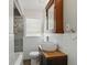 Stylish bathroom with vessel sink, custom vanity, and tiled shower-tub combination at 3255 W 30Th St, Indianapolis, IN 46222