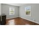 Bright bedroom featuring hardwood floors, fresh paint, and natural light from two windows at 3255 W 30Th St, Indianapolis, IN 46222